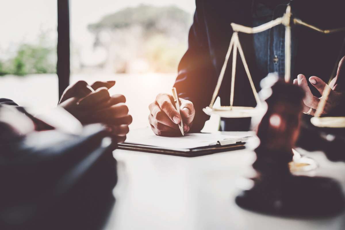 A man going through a lease agreement with another person, rules and regulations for tenants concept