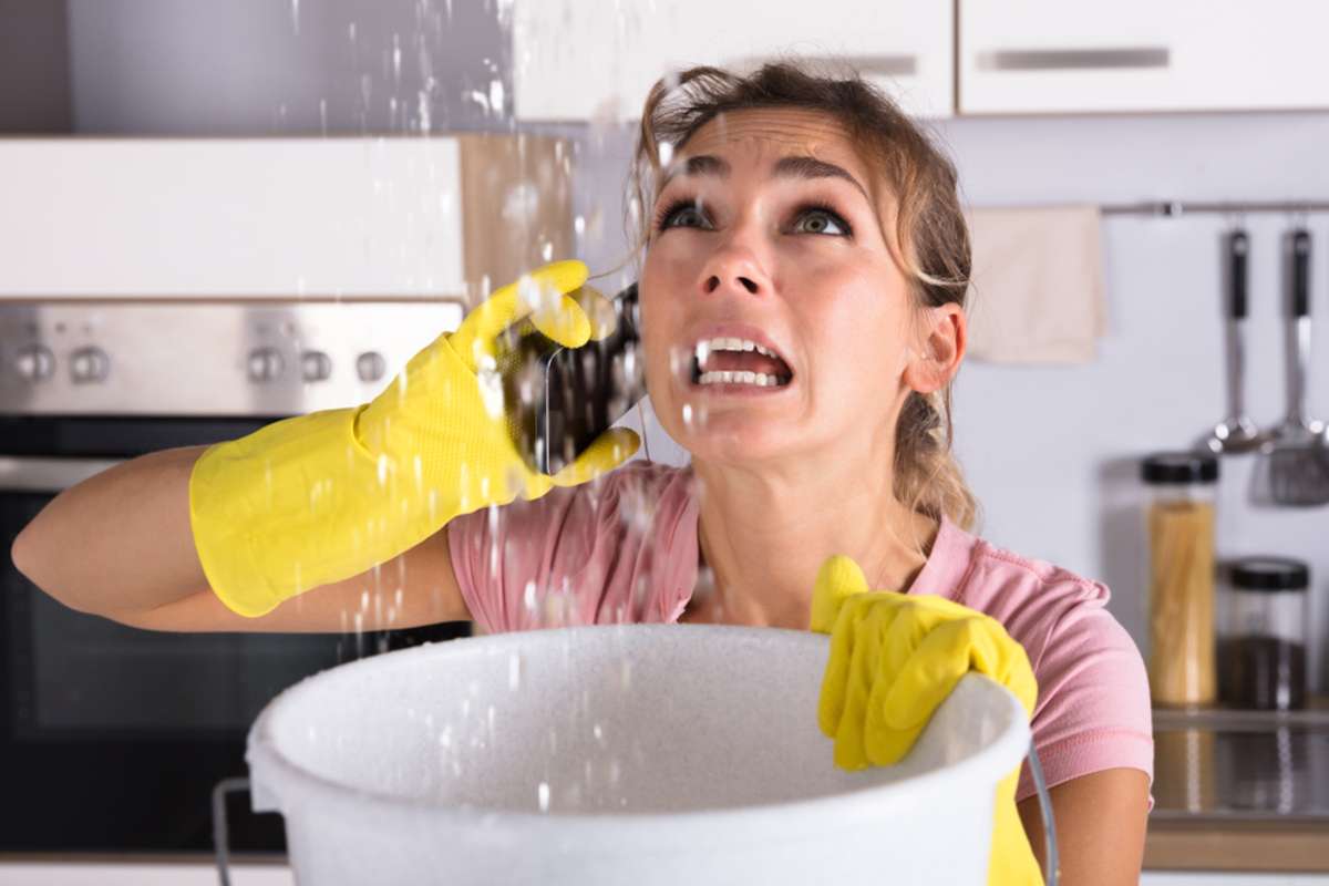 Panicked woman calls about water leaking from ceiling, property management companies Charleston, SC, concept